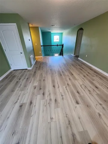 a view of a hallway with a window