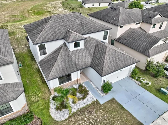 an aerial view of residential houses with outdoor space