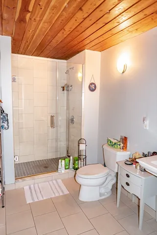 a bathroom with a toilet and a shower