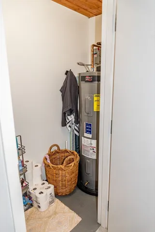 a room with water heater and utility racks