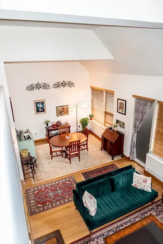 a living room with furniture rug and lamp