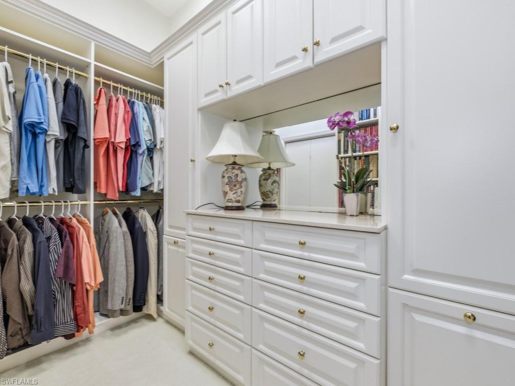 5835 Persimmon Way Naples, FL 34110 - Photo 13 of 50 a view of walk in closet with clothes and shoes