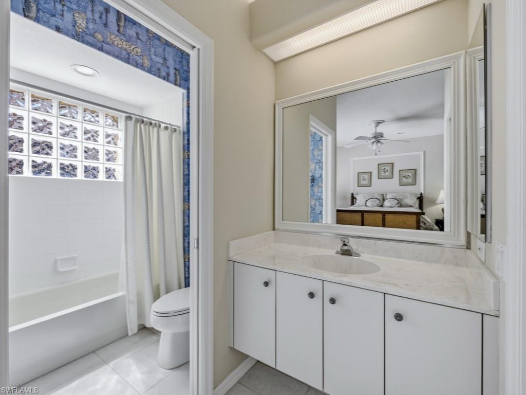 5835 Persimmon Way Naples, FL 34110 - Photo 15 of 50 a bathroom with a sink a toilet and shower