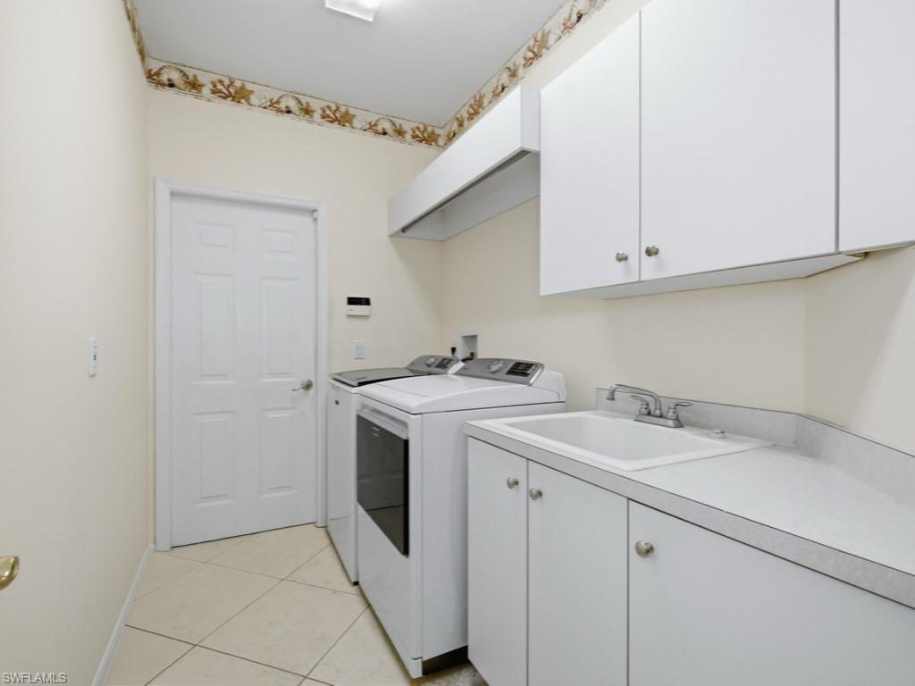 5835 Persimmon Way Naples, FL 34110 - Photo 18 of 50 a utility room with sink dryer and washer