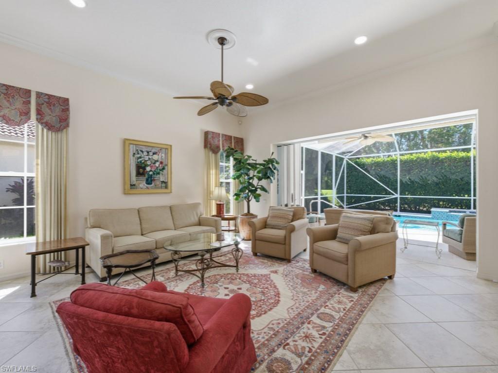 5835 Persimmon Way Naples, FL 34110 - Photo 4 of 50 a living room with furniture ceiling fan and a large window