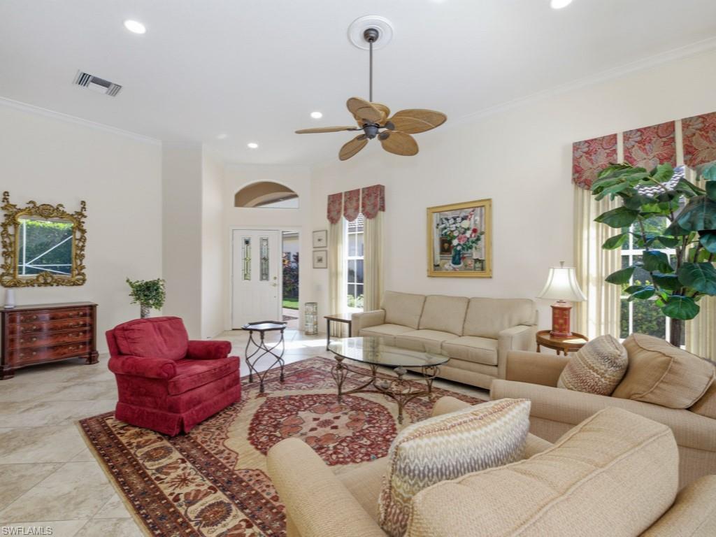 5835 Persimmon Way Naples, FL 34110 - Photo 7 of 50 a living room with furniture ceiling fan and a rug