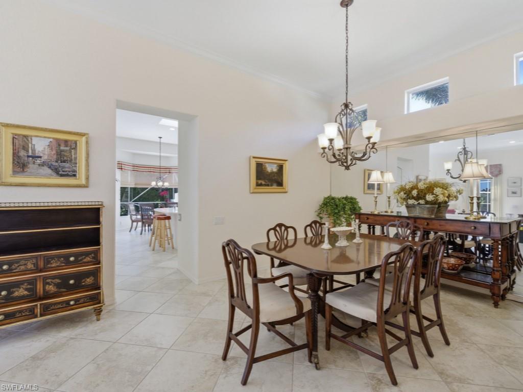 5835 Persimmon Way Naples, FL 34110 - Photo 9 of 50 a dining room with furniture a chandelier and window