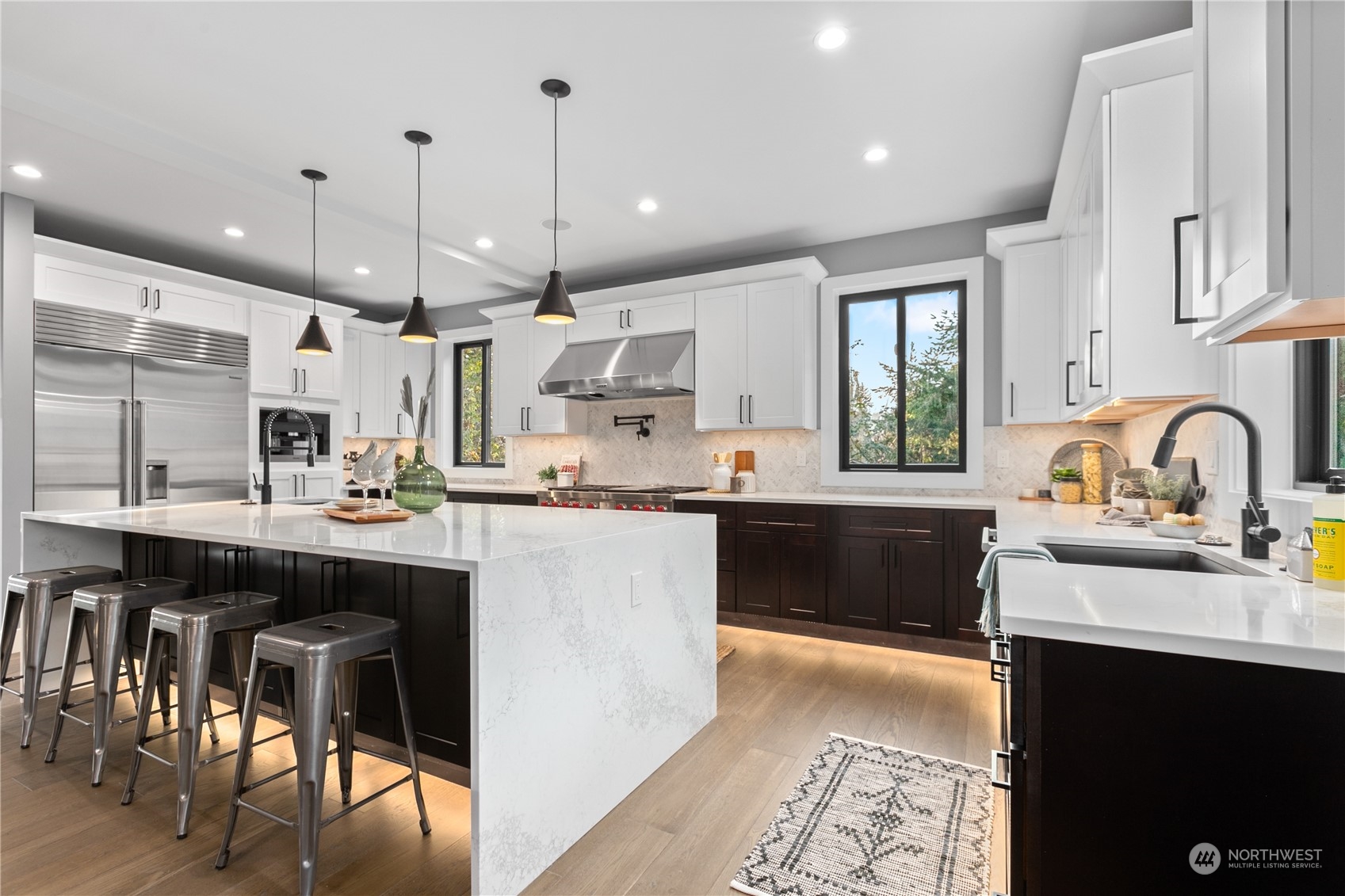 3015 Maynard Place Bellingham, WA 98226 - Photo 3 of 38 a kitchen with stainless steel appliances granite countertop a sink a stove a refrigerator and island with wooden floor