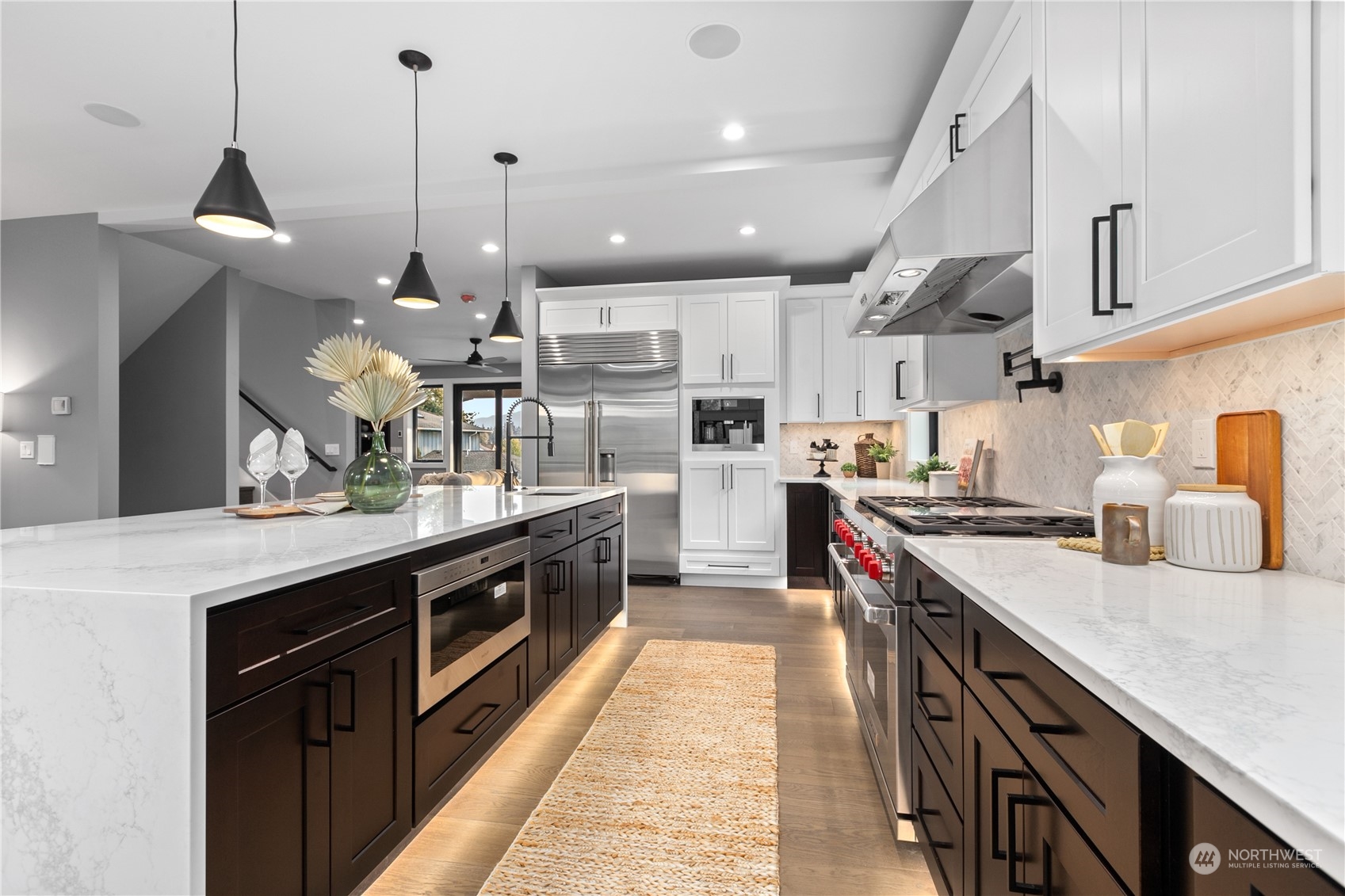 3015 Maynard Place Bellingham, WA 98226 - Photo 4 of 38 a kitchen with stainless steel appliances granite countertop a sink a stove and a wooden floors