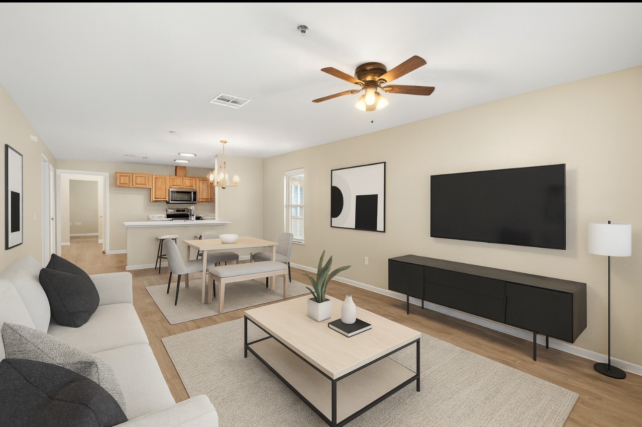 a living room with furniture a flat screen tv and kitchen view