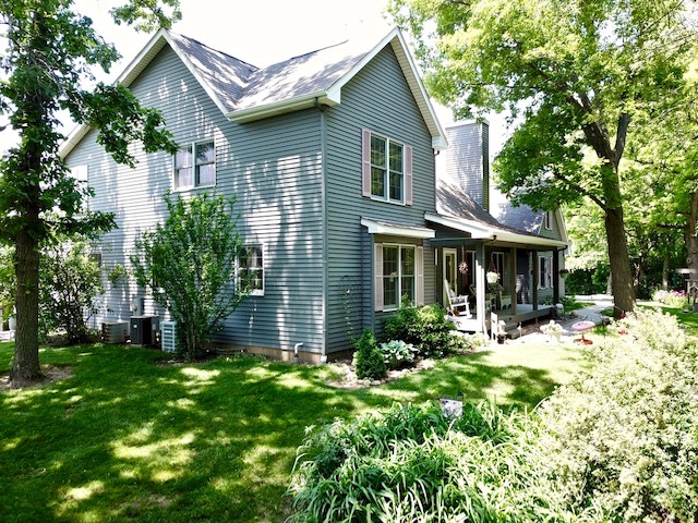 4115 Wilson Road Woodstock, IL 60098 - Photo 2 of 44 a front view of a house with a yard