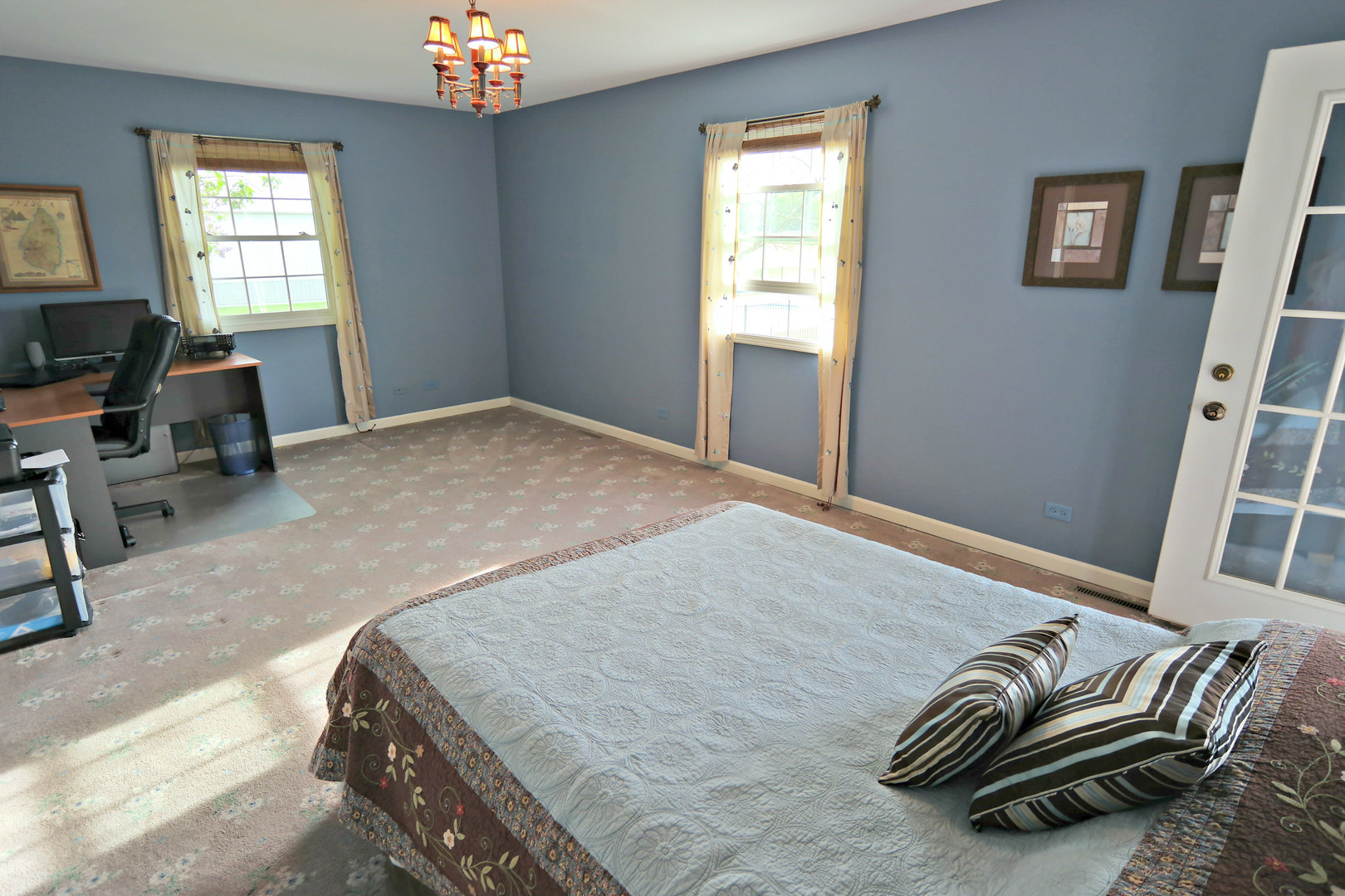 4115 Wilson Road Woodstock, IL 60098 - Photo 20 of 44 a bedroom with a bed and a chandelier