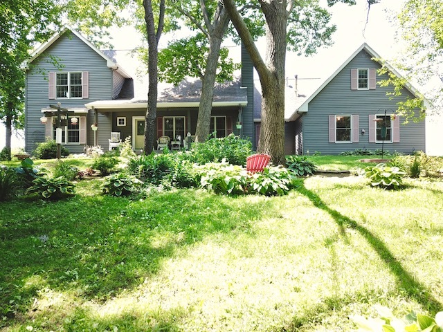 4115 Wilson Road Woodstock, IL 60098 - Photo 3 of 44 a front view of a house with a yard and trees