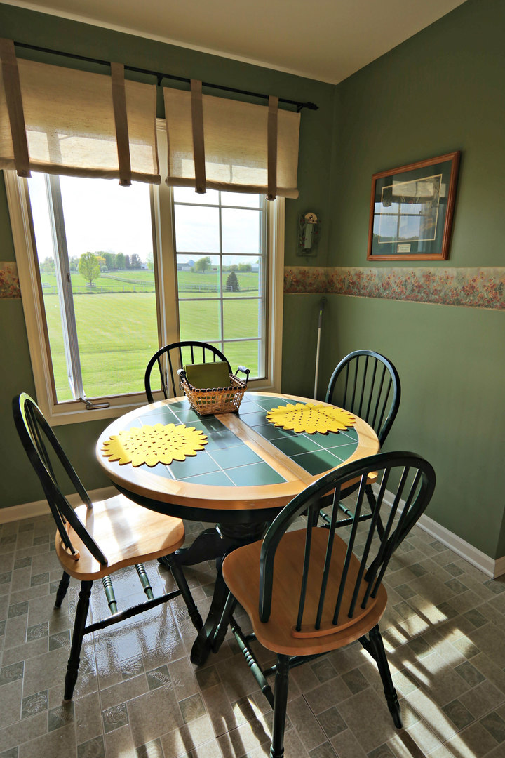 4115 Wilson Road Woodstock, IL 60098 - Photo 30 of 44 a view of a dining room with furniture window and outside view