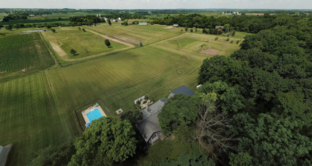 4115 Wilson Road Woodstock, IL 60098 - Photo 38 of 44 an aerial view of a house with a lake view