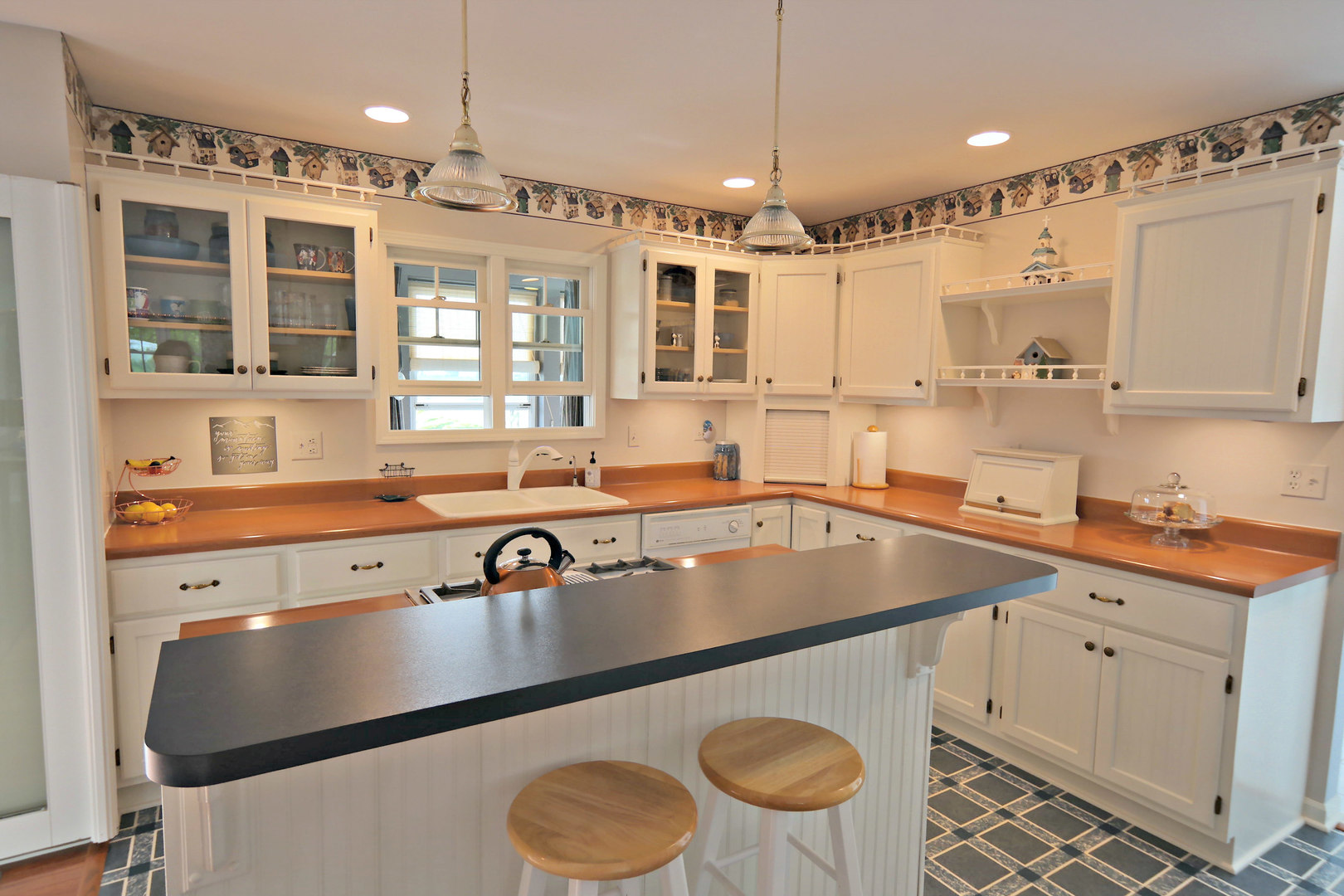 4115 Wilson Road Woodstock, IL 60098 - Photo 8 of 44 a kitchen with a sink a stove a dining table and chairs