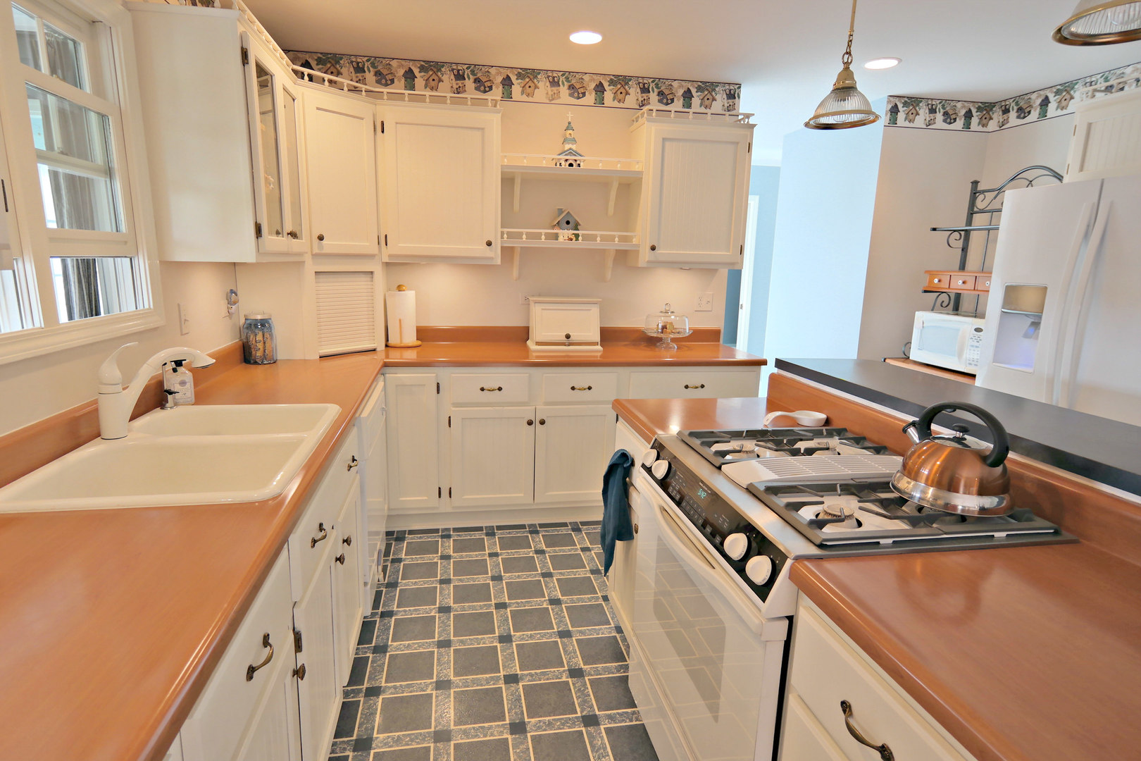 4115 Wilson Road Woodstock, IL 60098 - Photo 9 of 44 a kitchen with a sink stove and cabinets