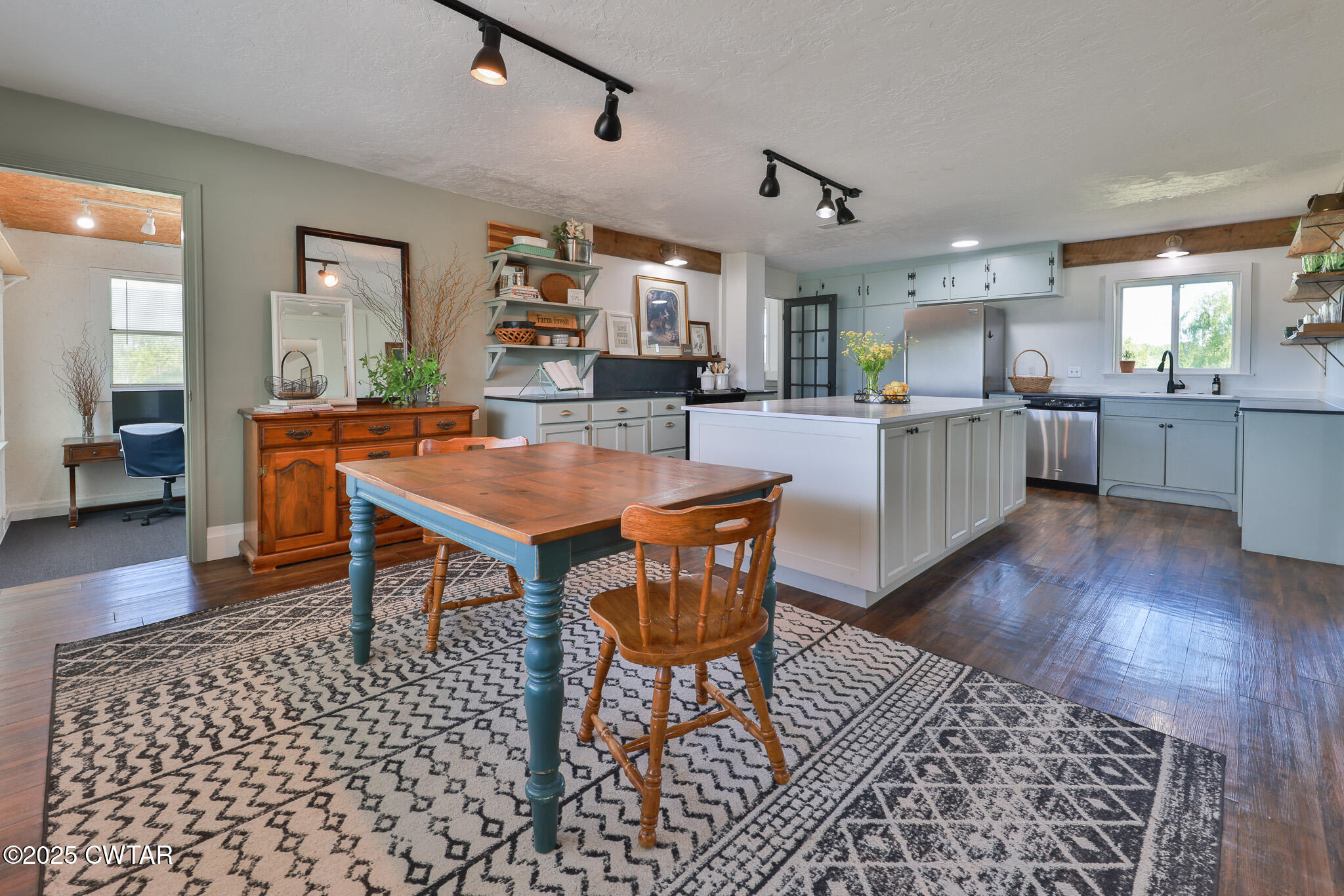 1461 Bynum Road Dresden, TN 38225 - Photo 22 of 60 a dining room with wooden floor a glass table and chairs