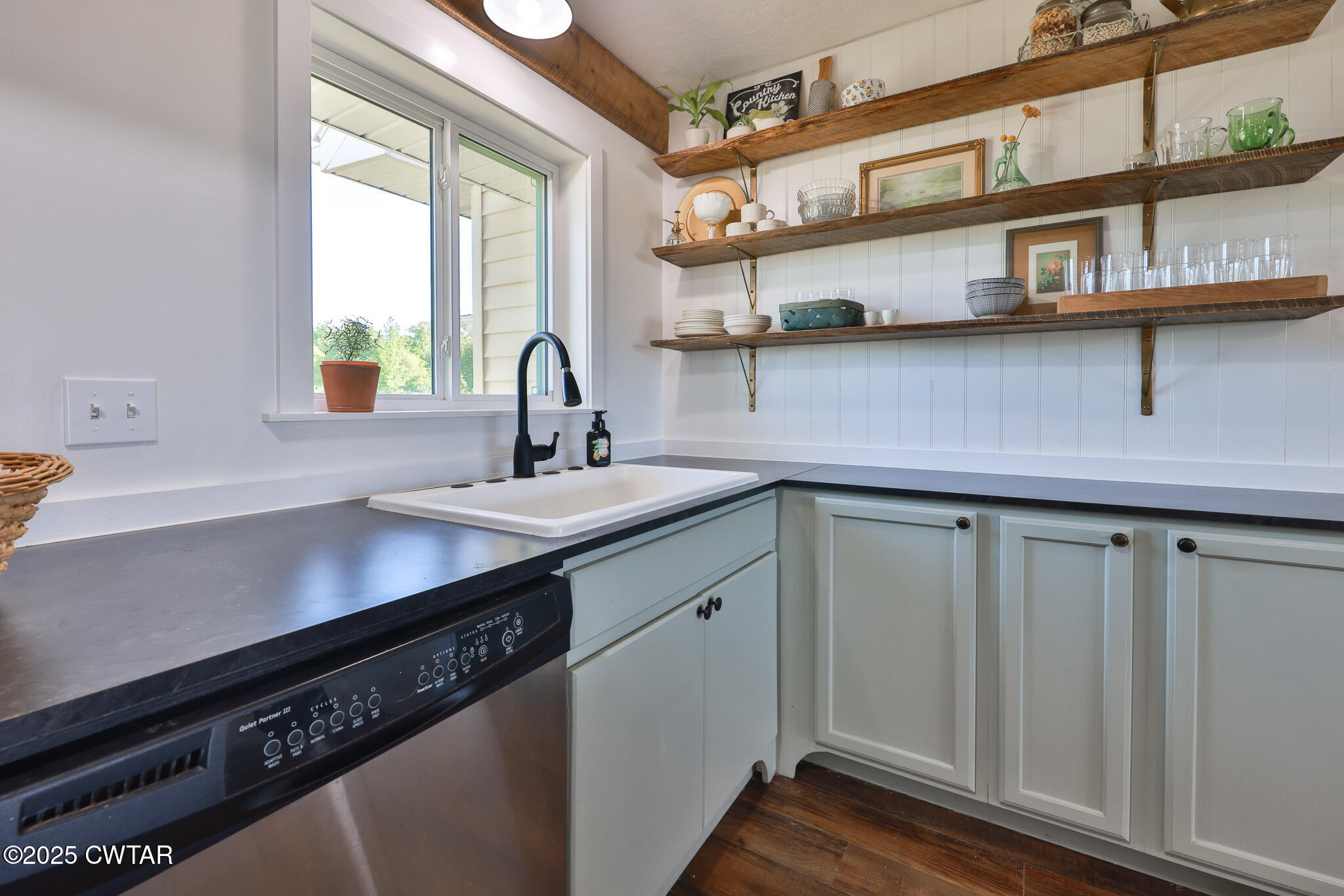 1461 Bynum Road Dresden, TN 38225 - Photo 24 of 60 a kitchen with stainless steel appliances a sink dishwasher a stove and white cabinets with wooden floor