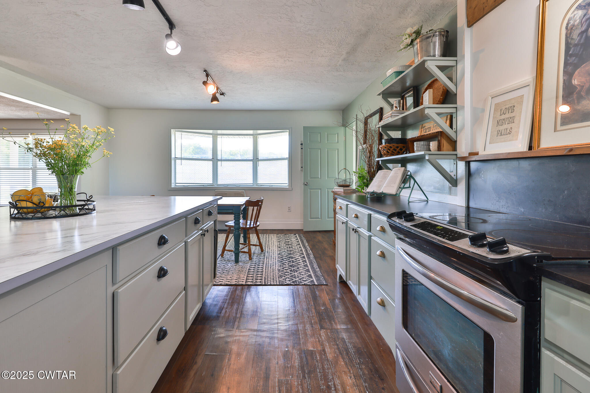 1461 Bynum Road Dresden, TN 38225 - Photo 25 of 60 a kitchen with stainless steel appliances a stove a sink a counter space and a window