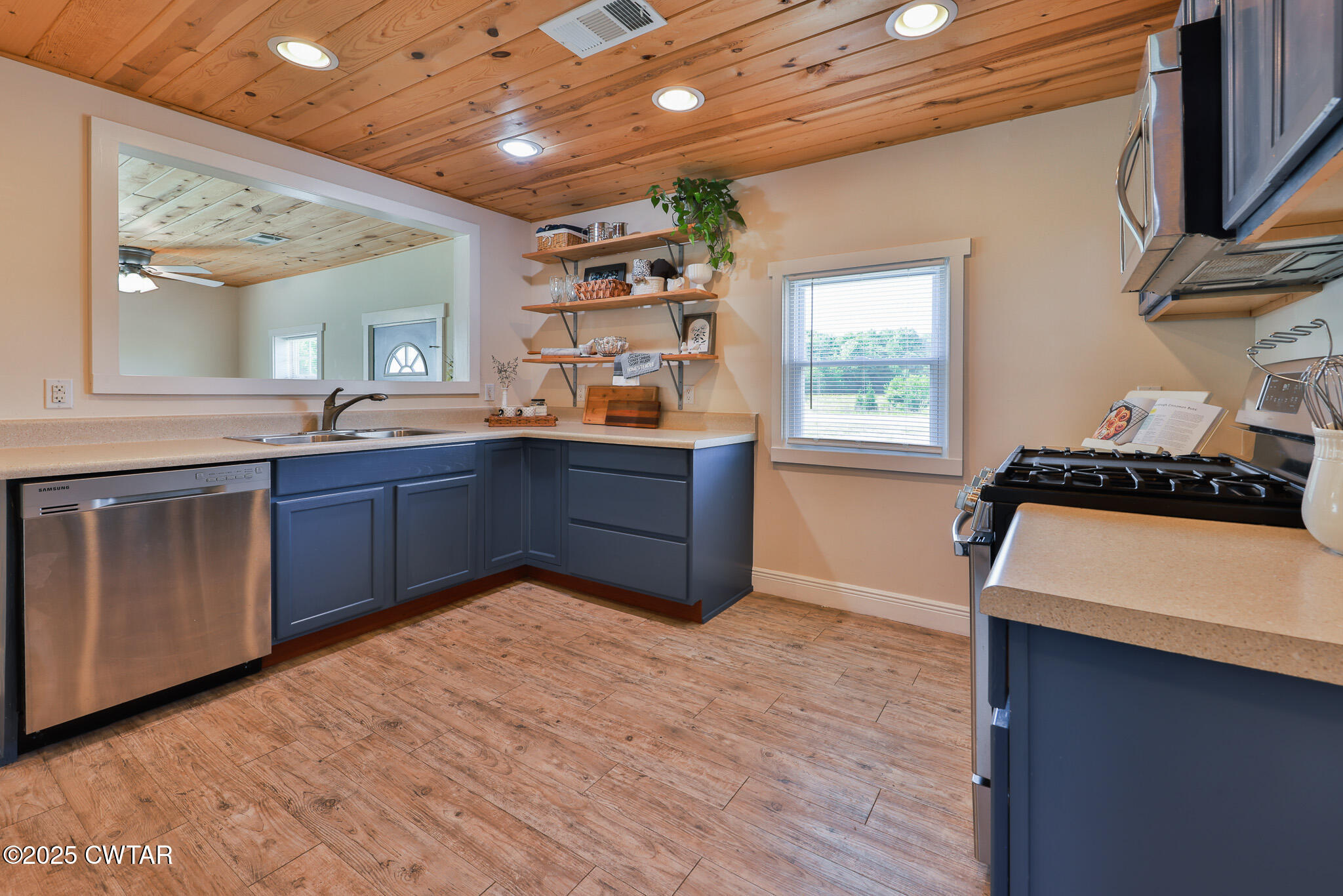 1461 Bynum Road Dresden, TN 38225 - Photo 49 of 60 a kitchen with stainless steel appliances granite countertop a sink a stove and a wooden floors