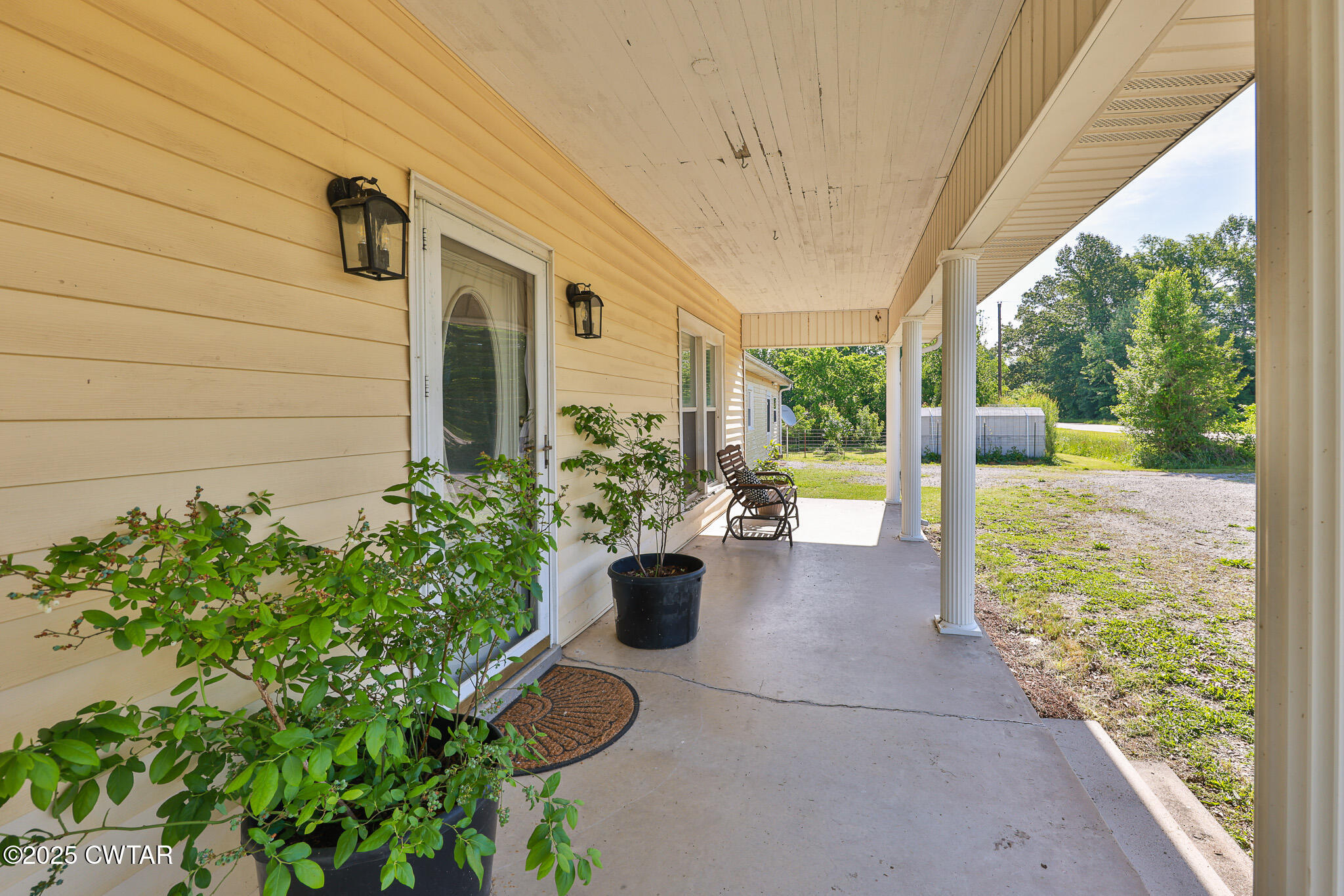1461 Bynum Road Dresden, TN 38225 - Photo 6 of 60 a view of a porch with chairs and potted plants
