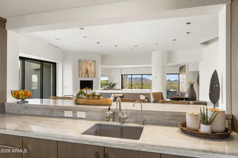 a large white bathroom with a large mirror vanity and bathtub