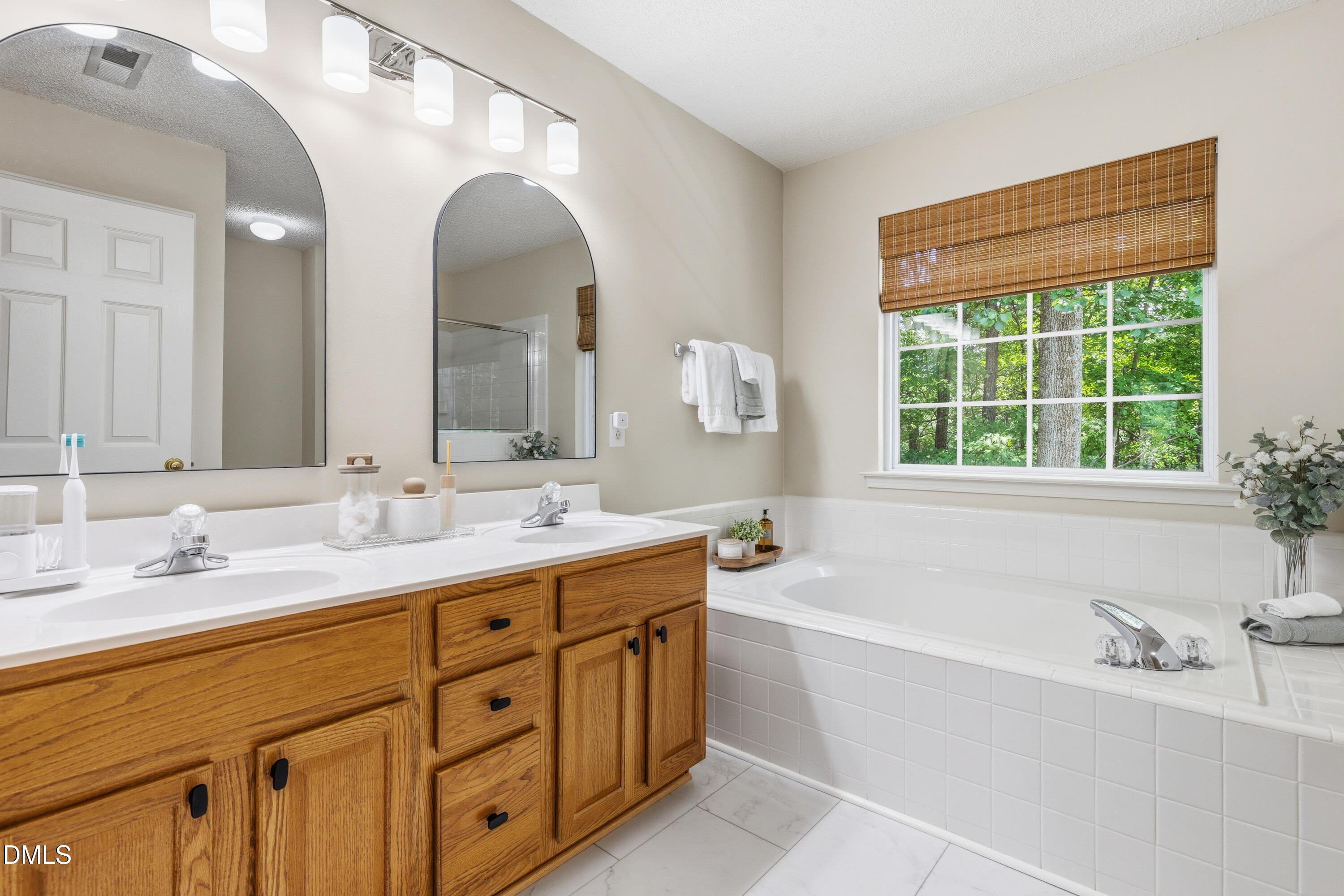 1211 Waterford Green Drive Apex, NC 27502 - Photo 33 of 53 a bathroom with a granite countertop sink mirror and a bathtub