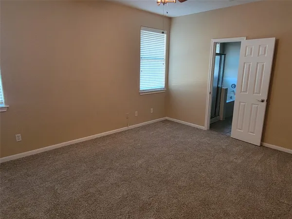 an empty room with windows and closet