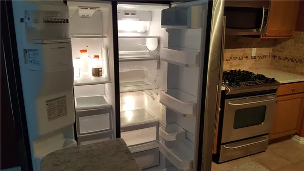 a kitchen with a refrigerator and a stove