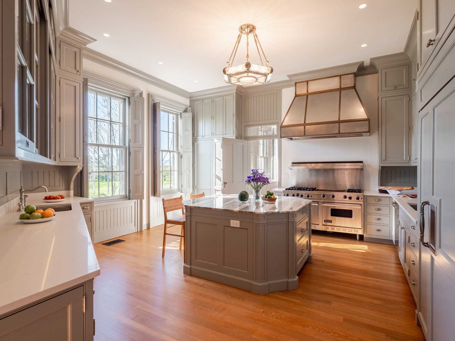 124 Eden Knoll Red Hook, NY 12571 - Photo 17 of 40 a kitchen with granite countertop a stove oven and a dining table with wooden floor