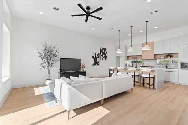 a living room with furniture and kitchen view
