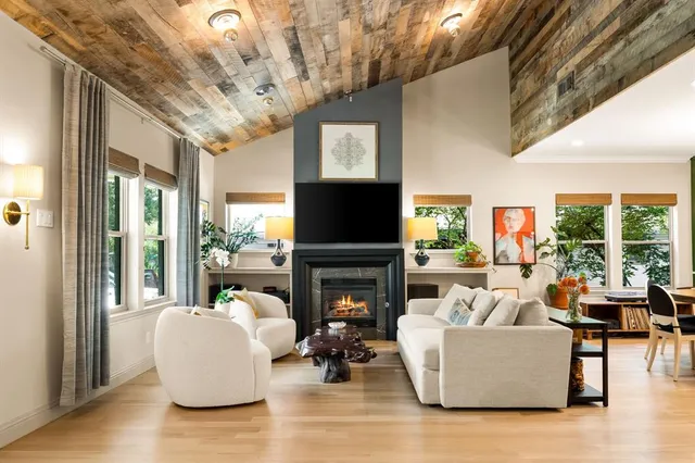 a living room with fireplace furniture and a flat screen tv