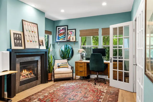 a living room with furniture a flat screen tv and a fireplace