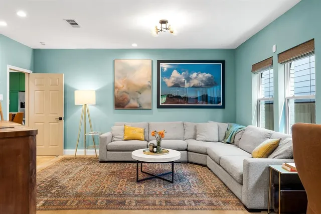a living room with furniture and a rug
