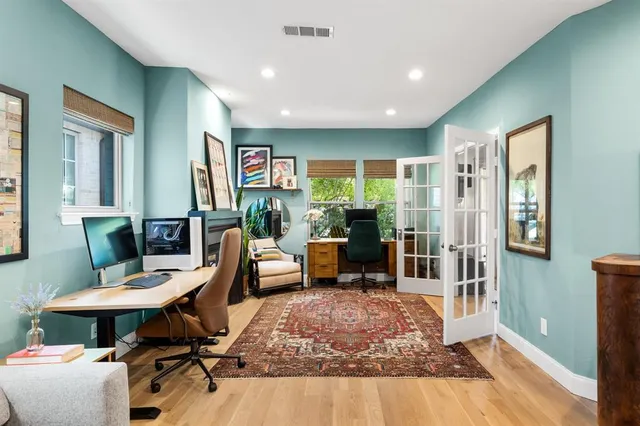 a bedroom with a bed and paintings on the wall