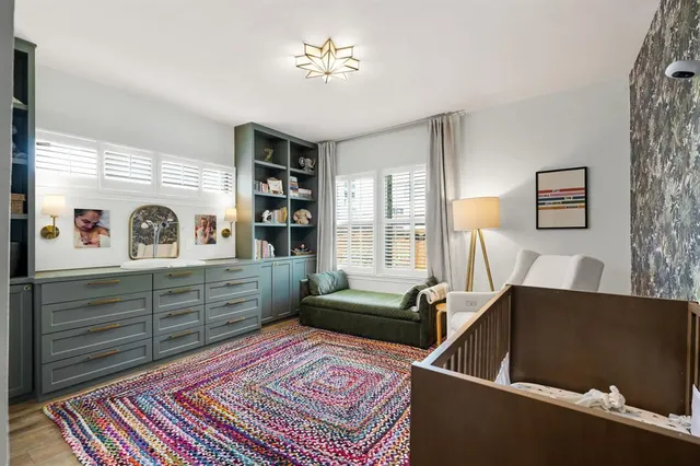 a bedroom with a large bed and a window