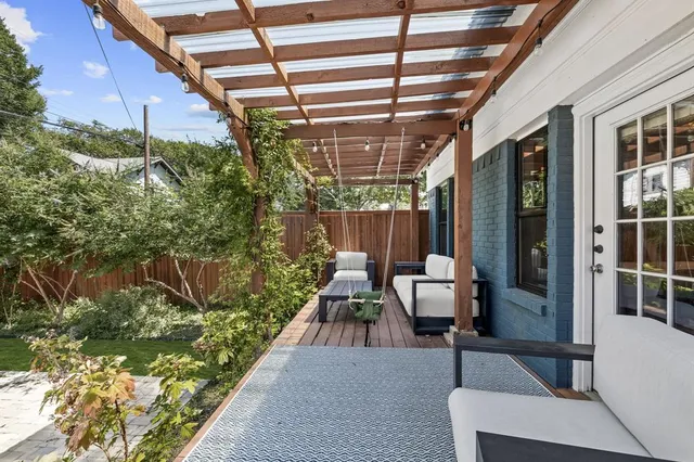 a view of a patio with a table and chairs and potted plants