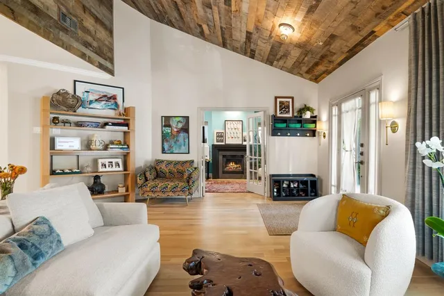 a living room with furniture a flat screen tv and a fireplace