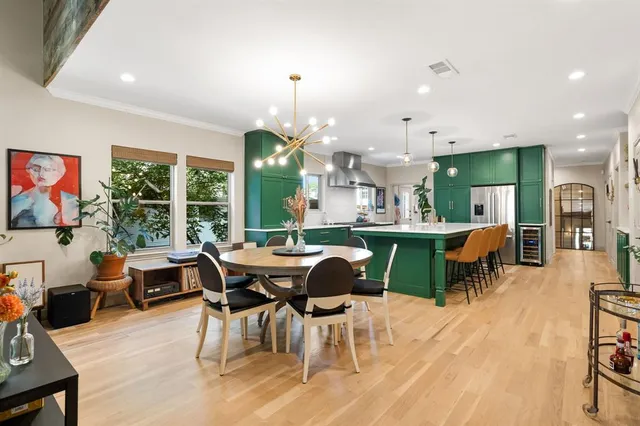 a dining room with stainless steel appliances kitchen island a table and chairs