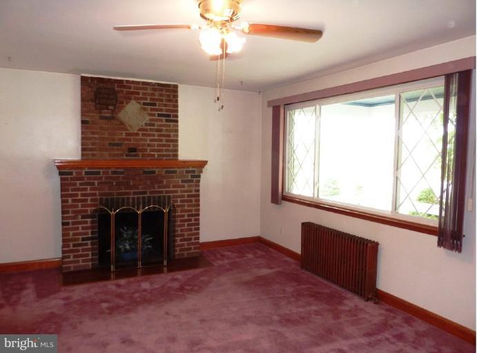 4307 Forge Road Perry Hall, MD 21128 - Photo 11 of 30 a living room with a fireplace and a large window