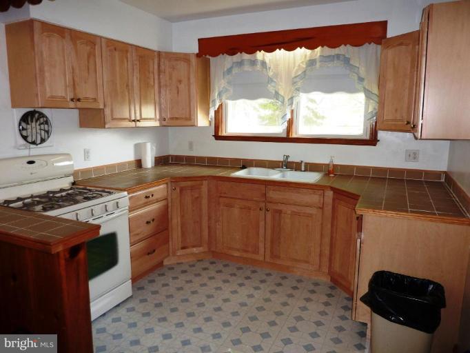 4307 Forge Road Perry Hall, MD 21128 - Photo 14 of 30 a kitchen with a sink a stove cabinets and a window