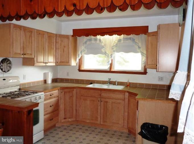 4307 Forge Road Perry Hall, MD 21128 - Photo 15 of 30 a kitchen with stainless steel appliances a stove a sink and a microwave