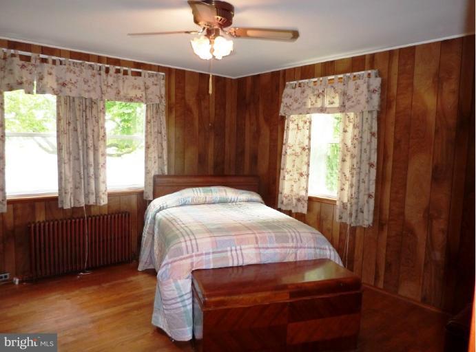 4307 Forge Road Perry Hall, MD 21128 - Photo 28 of 30 a bedroom with a bed and wooden floor
