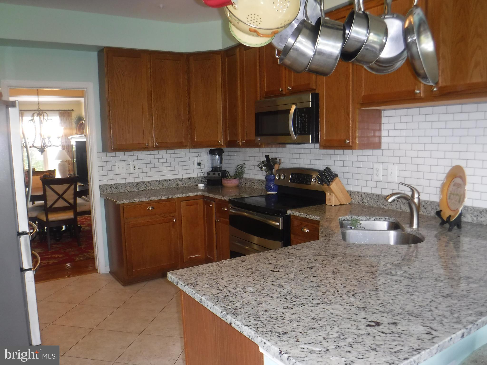 2444 Rippling Brook Road Frederick, MD 21701 - Photo 11 of 49 a kitchen with cabinets a sink and a stove