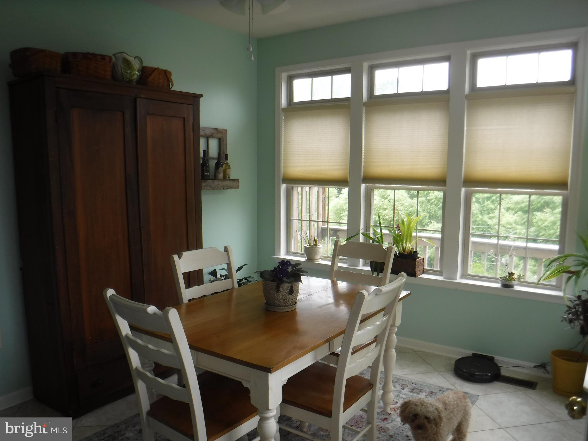 2444 Rippling Brook Road Frederick, MD 21701 - Photo 15 of 49 a view of a dining room with furniture and a window