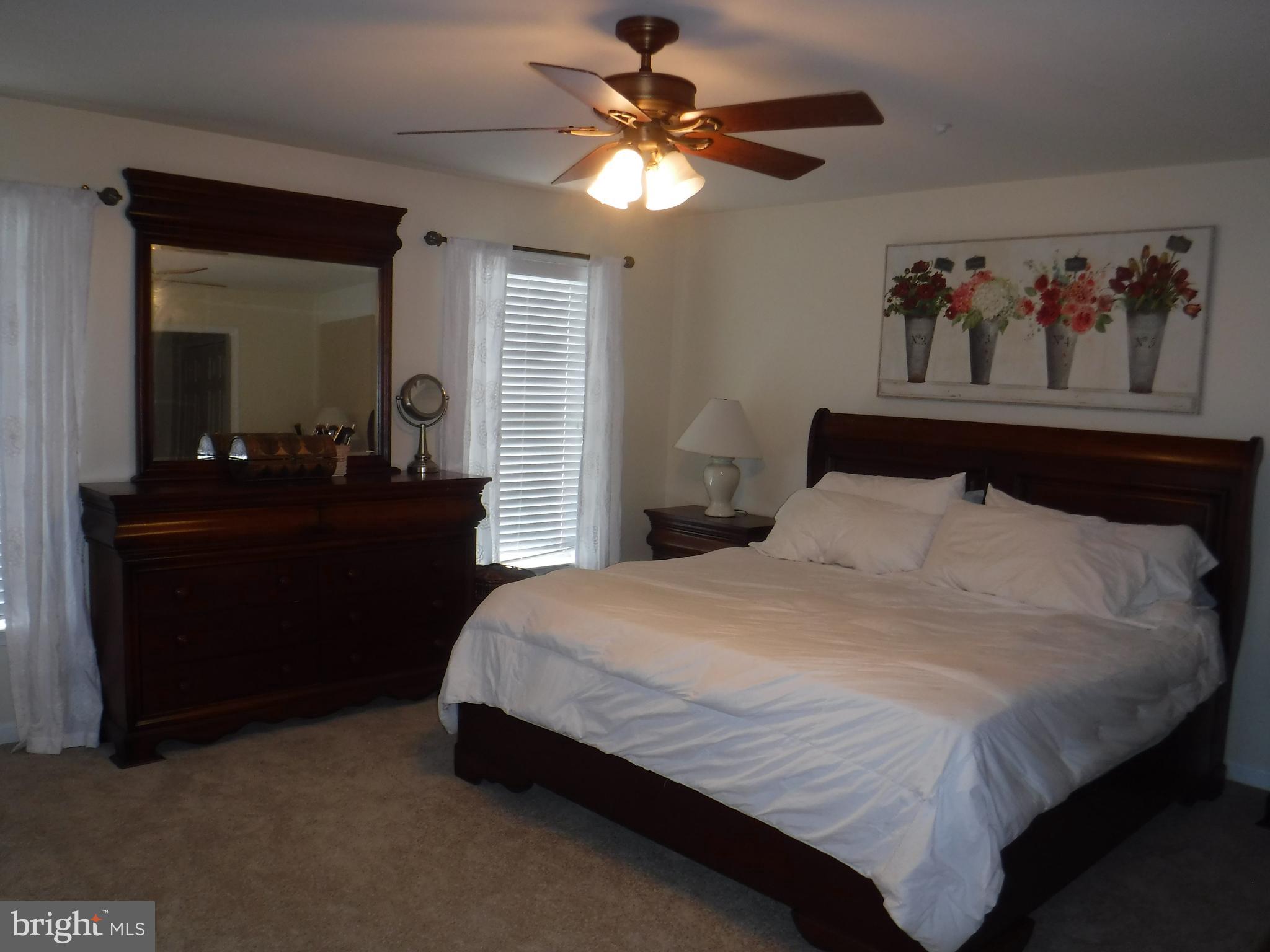 2444 Rippling Brook Road Frederick, MD 21701 - Photo 21 of 49 a bedroom with a bed and a chandelier