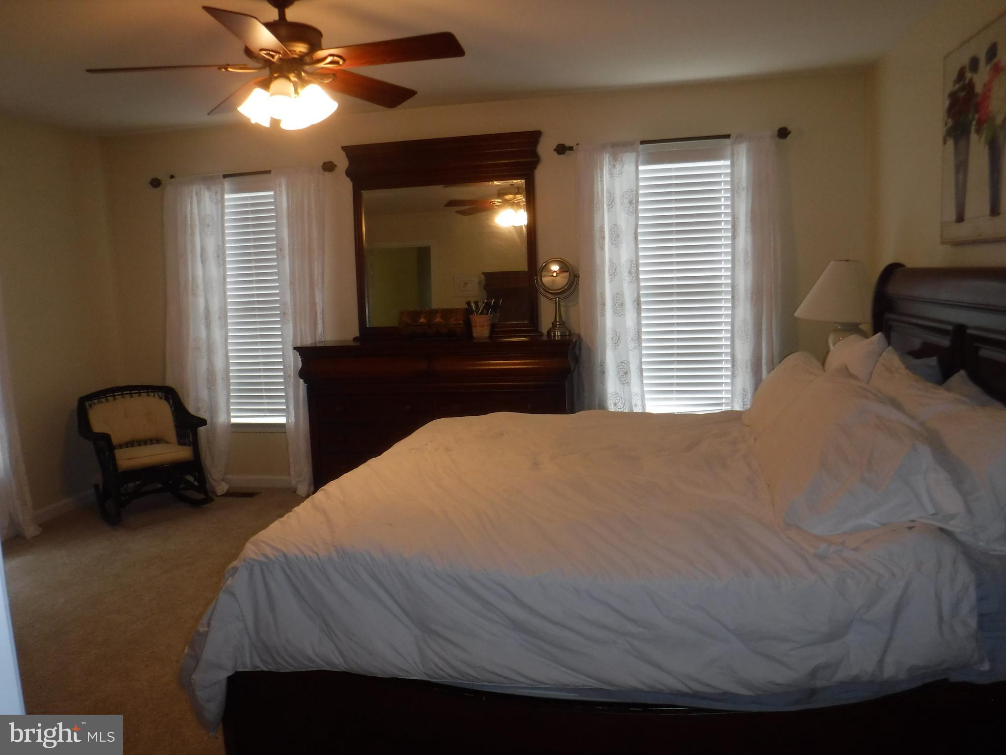 2444 Rippling Brook Road Frederick, MD 21701 - Photo 22 of 49 a bedroom with a bed and a chandelier