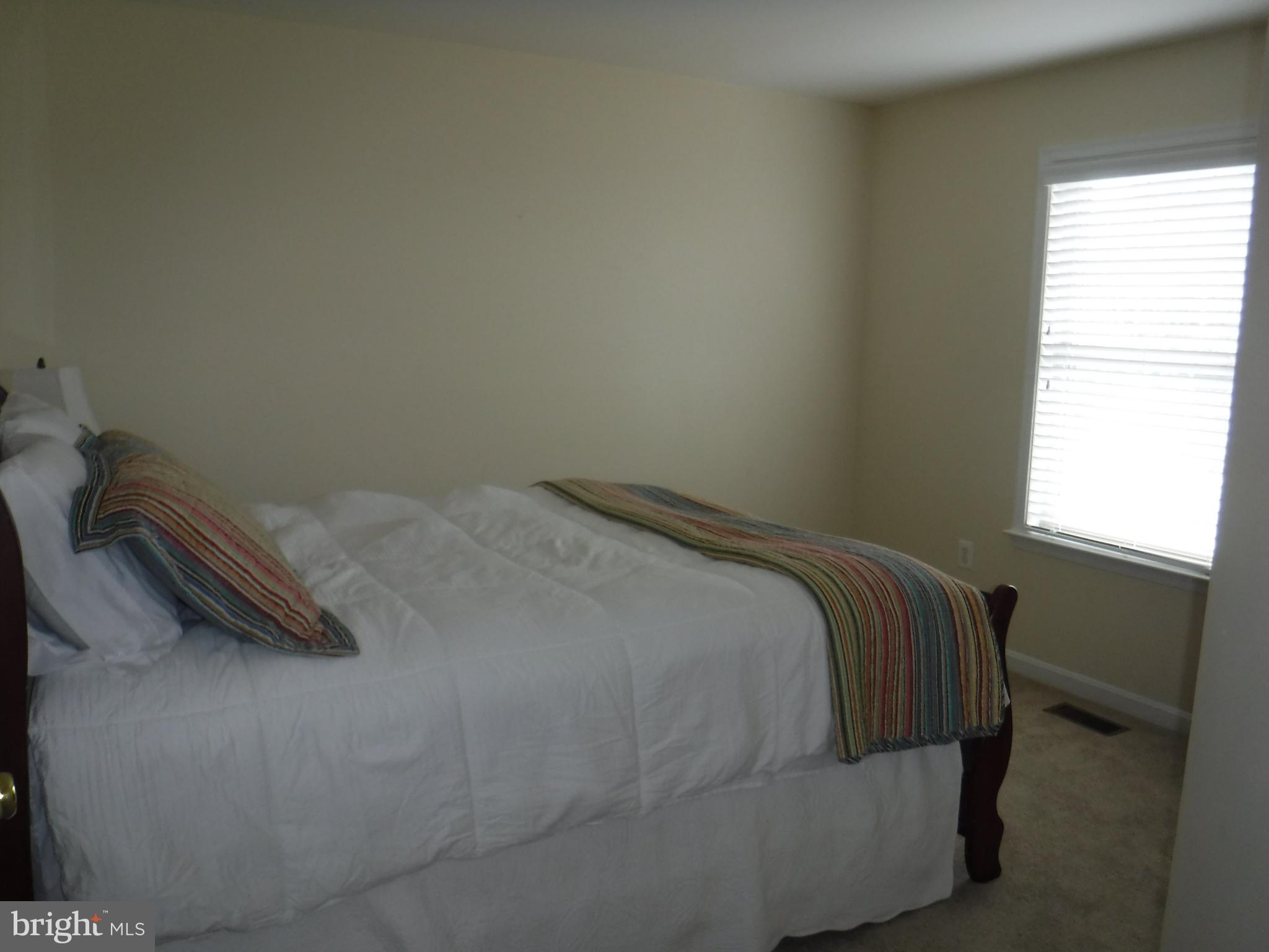 2444 Rippling Brook Road Frederick, MD 21701 - Photo 26 of 49 a bed sitting in a bedroom next to a window