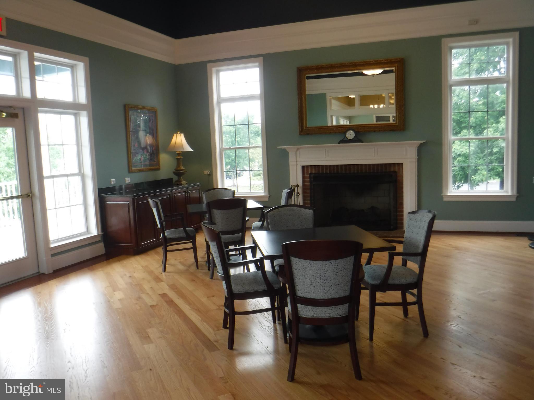 2444 Rippling Brook Road Frederick, MD 21701 - Photo 45 of 49 a dining room with furniture a fireplace and wooden floor